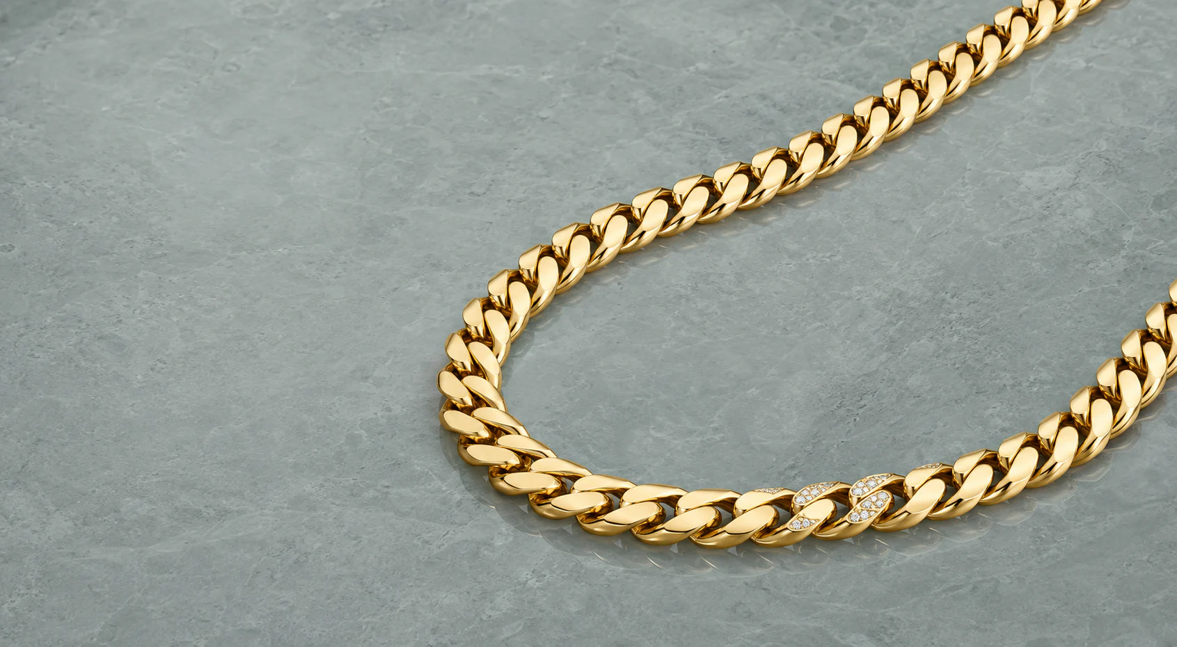 Yellow-gold curb chain with restrained diamond-set links